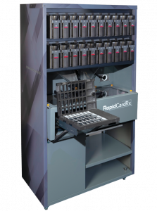 Automated card issuing workstation with a multi-slot card rack and printer labeled RapidCardRx inside a tall cabinet.
